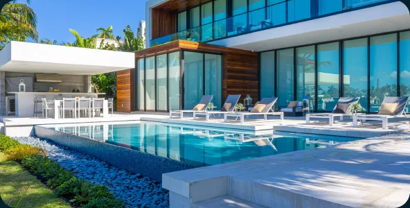 Poolside terrace with loungers at a modern Miami residence